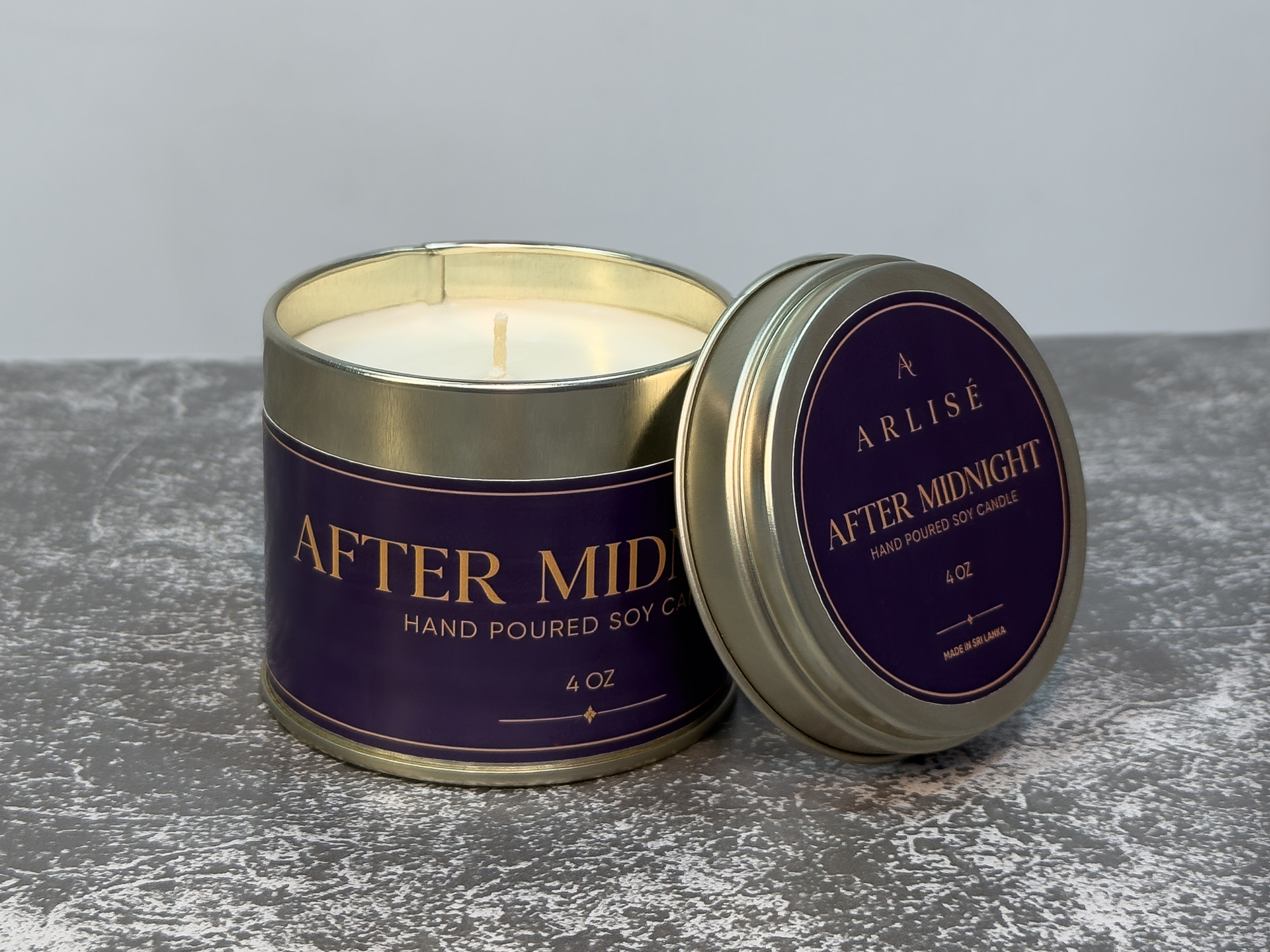 AFTER MIDNIGHT jasmine and green tea soy candle in its tin, unlit, in warm daylight